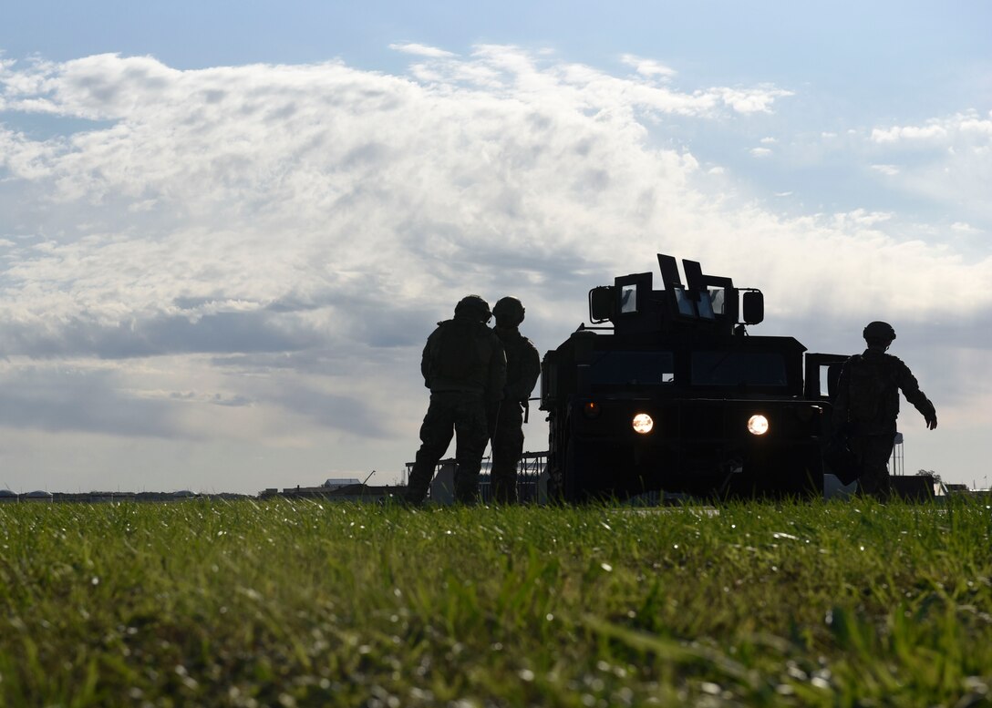 Airmen outside of a Humvee