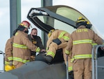 Lt. Col. Steven Augugliaro, 154th Wing F-22 flight safety officer, works with members of the Federal Fire Department during a pilot extraction exercise Nov. 20, 2020, at Joint Base Pearl Harbor-Hickam, Hawaii.