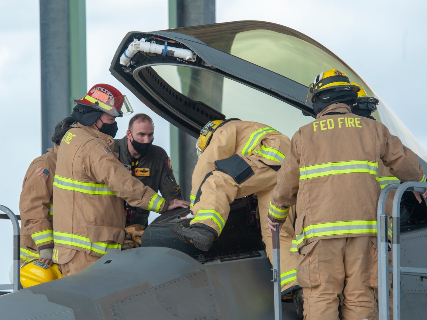 Lt. Col. Steven Augugliaro, 154th Wing F-22 flight safety officer, works with members of the Federal Fire Department during a pilot extraction exercise Nov. 20, 2020, at Joint Base Pearl Harbor-Hickam, Hawaii.
