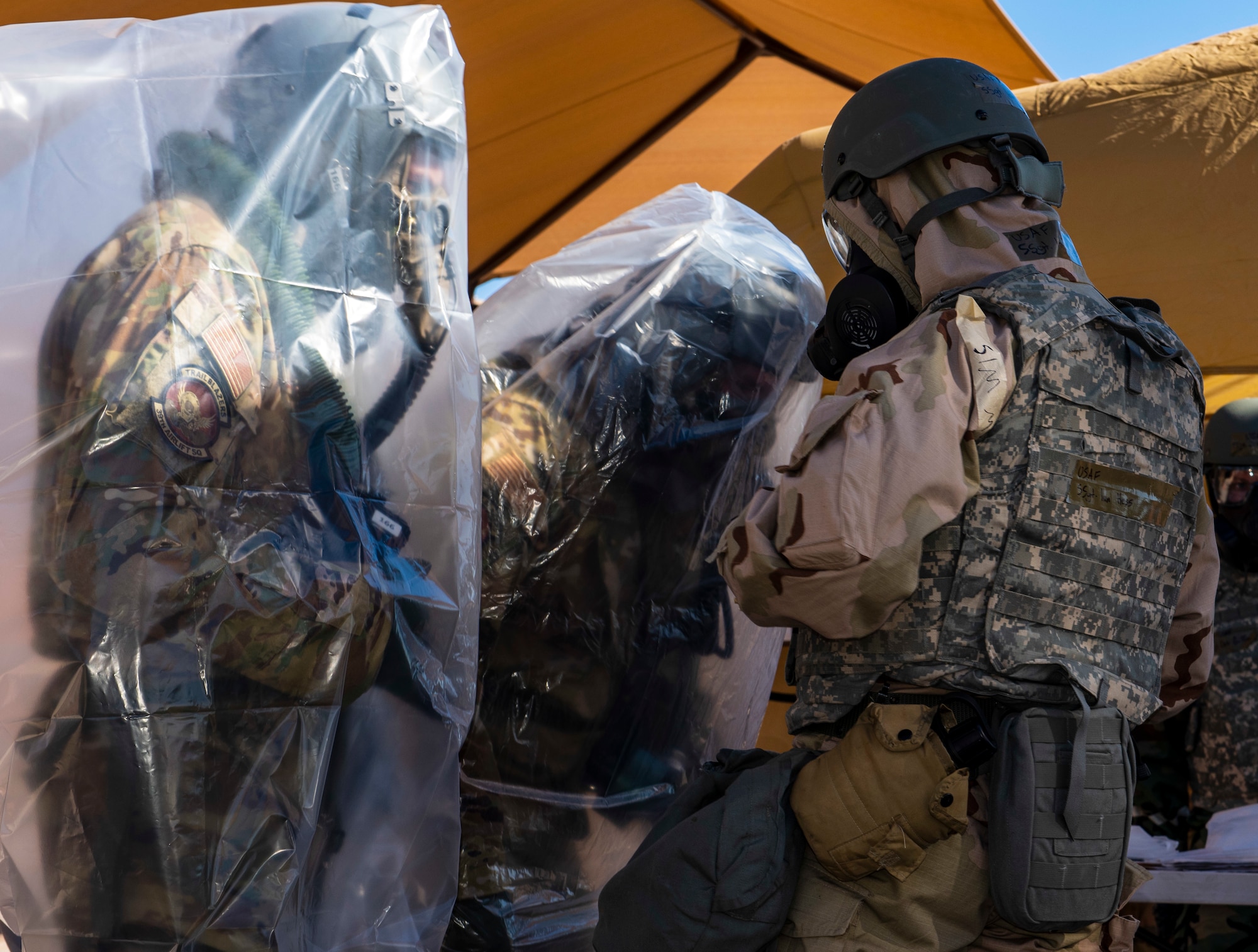Pilots from the 317th Airlift Wing are inspected before going through a decontamination line at Dyess Air Force Base, Texas, Nov. 17, 2020.