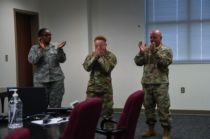 Senior Airman Sidni Muldrow, a relocations journeyman with the 628th Force Support Squadron, Col. Katrina Terry, 628th Mission Support Group commander, and Chief Master Sgt. Jason Colon, 628th Air Base Wing command chief, participate in a teleconference with Air Mobility Command leadership at Joint Base Charleston, S.C., Nov. 24, 2020. Muldrow was recognized for being selected for the Senior Leader Enlisted Commissioning Program – Active Duty during the teleconference.