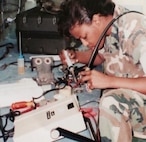 IMAGE: DAHLGREN, Va. – Duanna ‘Kimberly’ Tanner – keynote speaker at the 2020 Naval Surface Warfare Center Dahlgren Division virtual Veterans Day Observance – repairs a communication system while on active duty as a Marine ground radio repairman. “We’re entitled to modify our personal branding to support the current environment that we live in,” said Tanner, a former debutante and current Marine Corps Systems Command project manager, who encouraged veterans, government employees and contractors tuning in via Teams to rebrand themselves while transitioning throughout their careers. (Photo courtesy of Duanna ‘Kimberly’ Tanner/Released)