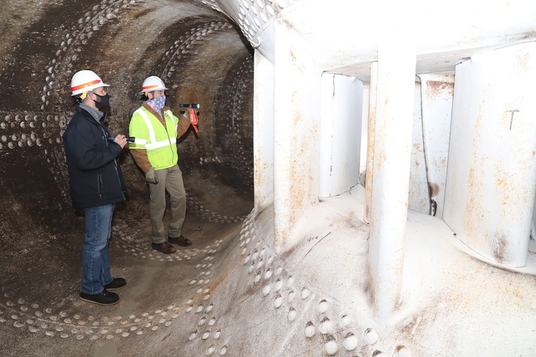 Ryan Brockman (left), District project manager, hydropower, and Dale Pugh, Ft. Peck Dam operations manager, inspect a turbine during a site visit, Oct. 29, 2020.