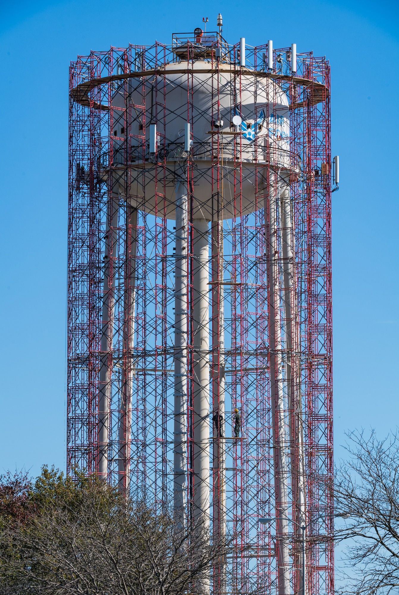 Scaffolding surrounds the base water tower as employees from Allied Painting Inc., Cherry Hill, New Jersey, prepare to conduct periodic internal and external maintenance to the  tower November 5, 2020, on Dover Air Force Base, Delaware. The water tower is operated by Tidewater Utilities Inc. which was also subcontracted for the blasting and painting of the tower. Site preparation and mobilization started on August 24 with a projected completion date in December, weather permitting. (U.S. Air Force photo by Roland Balik)