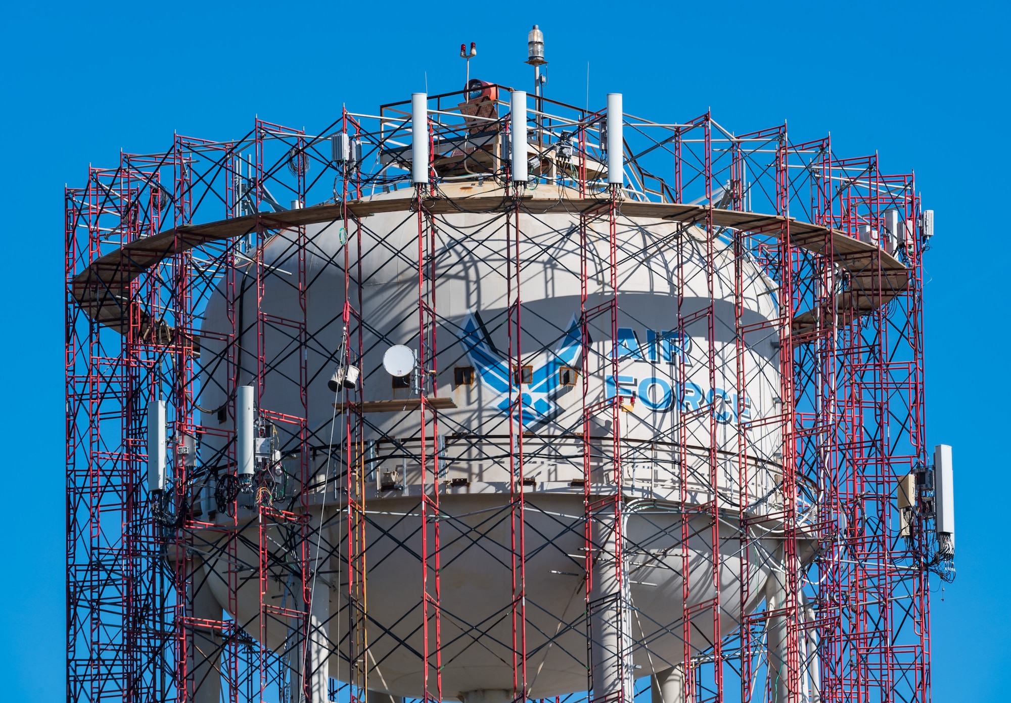 Scaffolding surrounds the base water tower as employees from Allied Painting Inc., Cherry Hill, New Jersey, prepare to conduct periodic internal and external maintenance to the  tower November 5, 2020, on Dover Air Force Base, Delaware. The water tower is operated by Tidewater Utilities Inc. which was also subcontracted for the blasting and painting of the tower. Site preparation and mobilization started on August 24 with a projected completion date in December, weather permitting. (U.S. Air Force photo by Roland Balik)