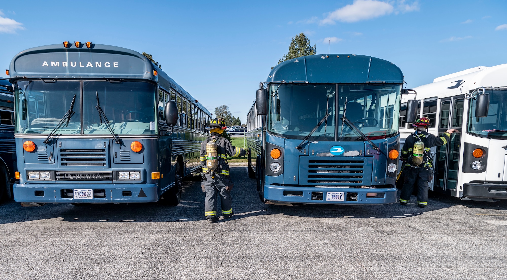 Firefighters from the 436th Civil Engineer Squadron search logistic readiness squadron buses for a suspicious package during a force protection exercise Nov. 18, 2020, at Dover Air Force Base, Delaware. Team Dover first responders were tested through numerous scenarios, to help ensure the continued safety of base personnel and assets. (U.S. Air Force photo by Senior Airman Christopher Quail)