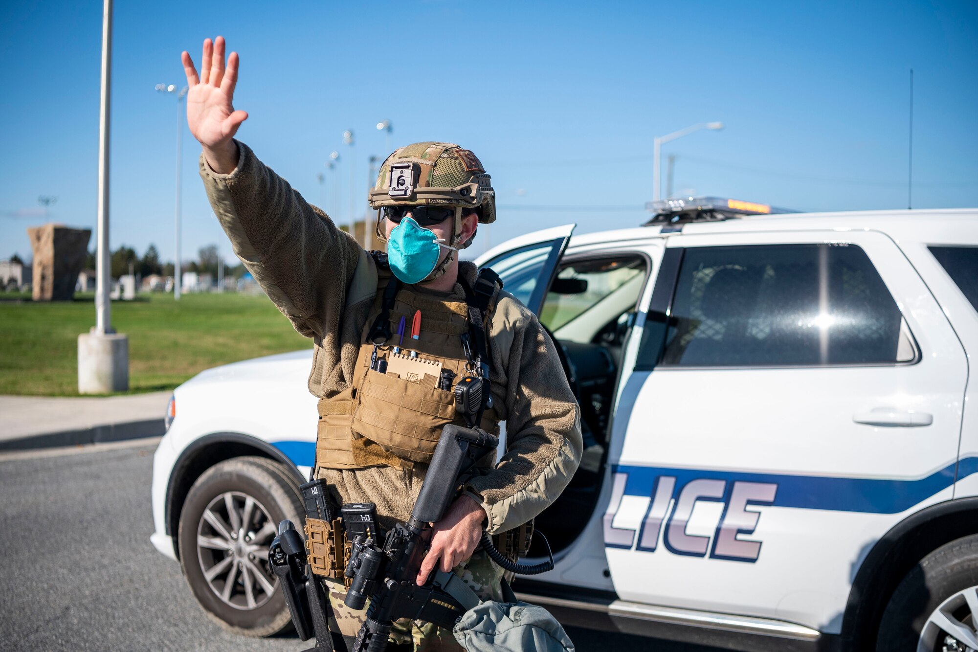 Tech. Sgt. Mark Devine, 436th Security Force Squadron flight sergeant, stops traffic to create a cordon during a suspicious package during a force protection exercise inject Nov. 18, 2020, at Dover Air Force Base, Delaware. Team Dover first responders were tested through numerous scenarios, ensuring the safety of base personnel and assets. (U.S. Air Force photo by Senior Airman Christopher Quail)