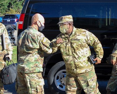 Col. Michael Rivera, commander, 404th Army Field Support Brigade, greets Maj. Gen. David Wilson, 8th Theater Sustainment Command, as he visits the 404th AFSB Headquarters Nov. 9.