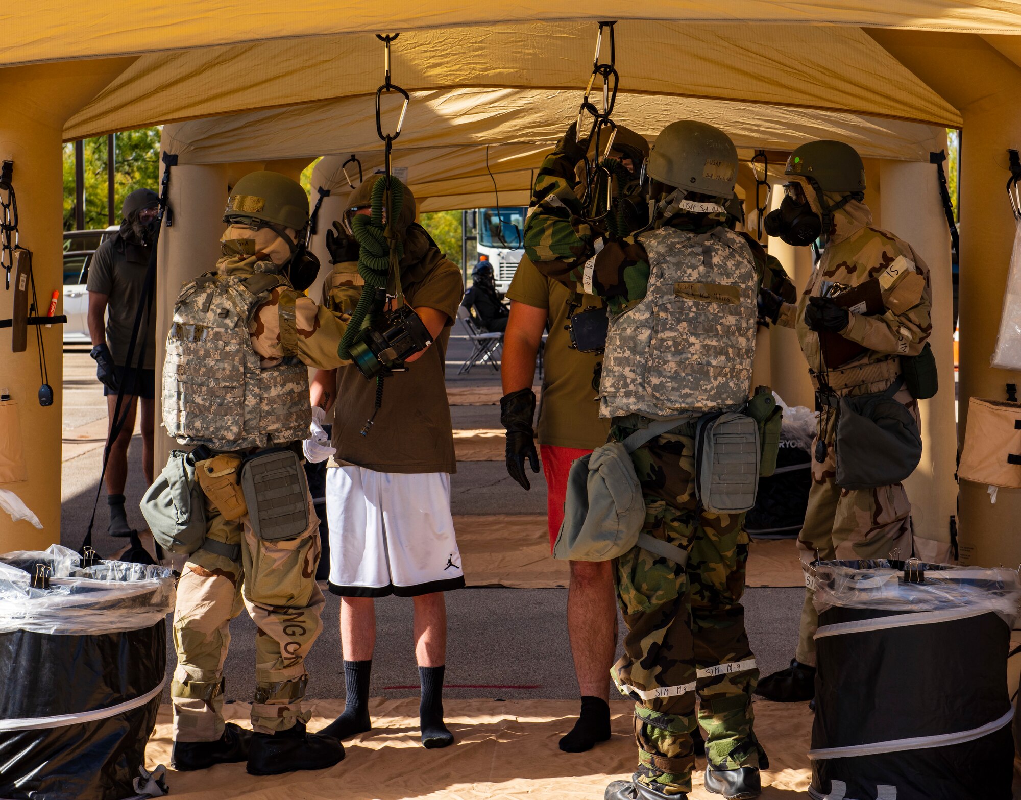 Aircrew from the 317th Airlift Wing are walked through a decontamination line at Dyess Air Force Base, Texas, Nov. 17, 2020.