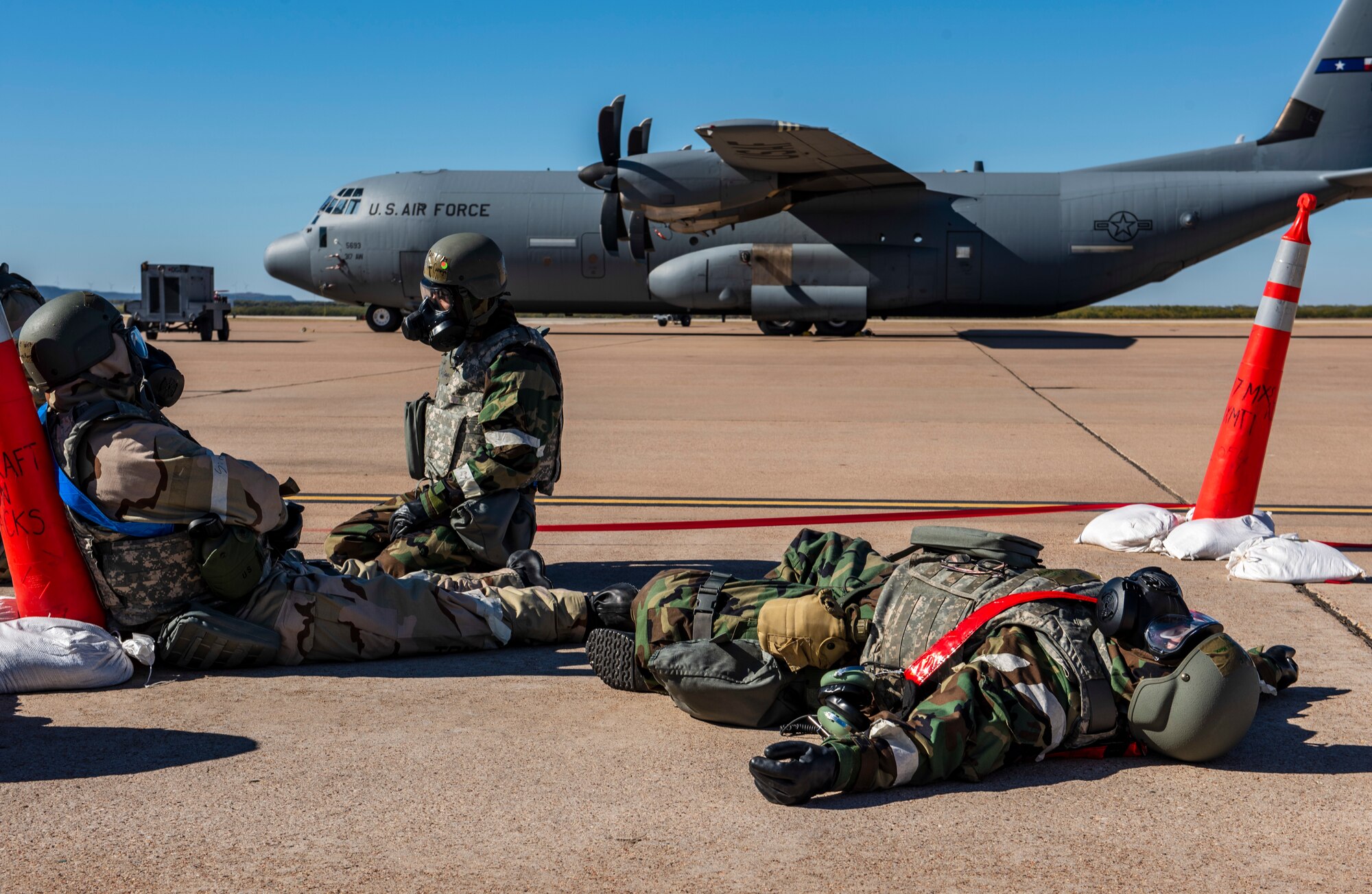 Airmen assigned to the 317th Aircraft Maintenance Squadron rest in a simulated bunker on the flightline as they wait for perimeter sweeps to finish during an exercise at Dyess Air Force Base, Texas, Nov. 18, 2020.