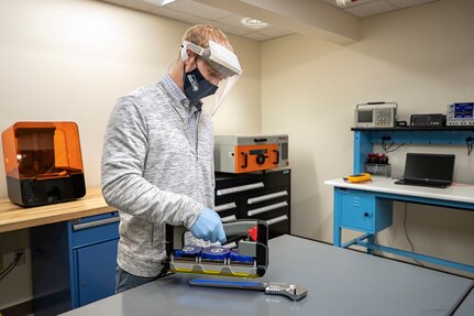 Branden Doyle, Code 2301 nuclear innovation program manager, sanitizes a crescent wrench Nov. 13, 2020 using a UVC-LED Handheld Sanitizer designed by employees in the PSNS Innovation Lab in Building 435 at Puget Sound Naval Shipyard & Intermediate Maintenance Facility in Bremerton, Washington. (PSNS & IMF photo by Scott Hansen)