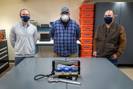 Employees (from left) Branden Doyle, Code 2301 nuclear innovation program manager, Wilson Davenport, Code 290 electrical engineer, and Christopher Doyle, Code 2310 nuclear planning engineer, recently designed and built two UVC-LED Handheld Sanitizer prototypes for use on U.S. Navy vessels and at Naval facilities worldwide in the PSNS Innovation Lab at Puget Sound Naval Shipyard & Intermediate Maintenance Facility in Bremerton, Washington. (PSNS & IMF photo by Scott Hansen)