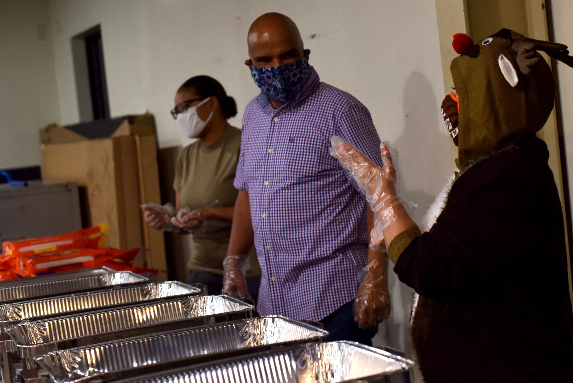 Volunteers prepare to serve the early Thanksgiving meal at The Crossroads Student Center on Goodfellow Air Force Base, Texas, Nov. 24, 2020. Volunteers wore masks and gloves while serving food for students. (U.S. Air Force photo by Staff Sgt. Seraiah Wolf)