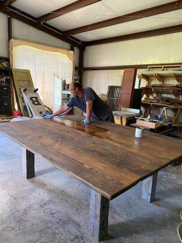 Aaron Boswell finishing a handmade table