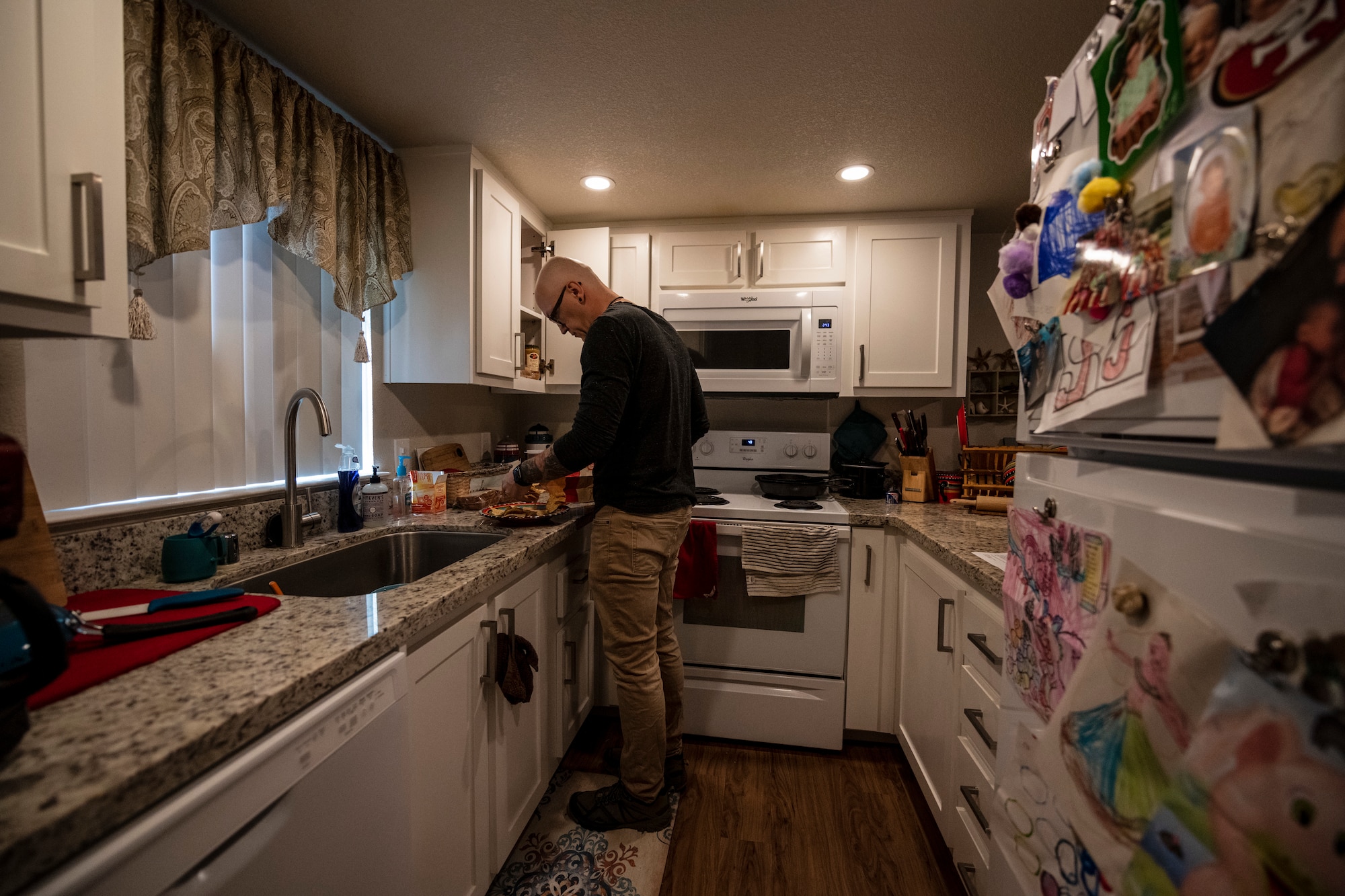 A man creates a meal in his kitchen.