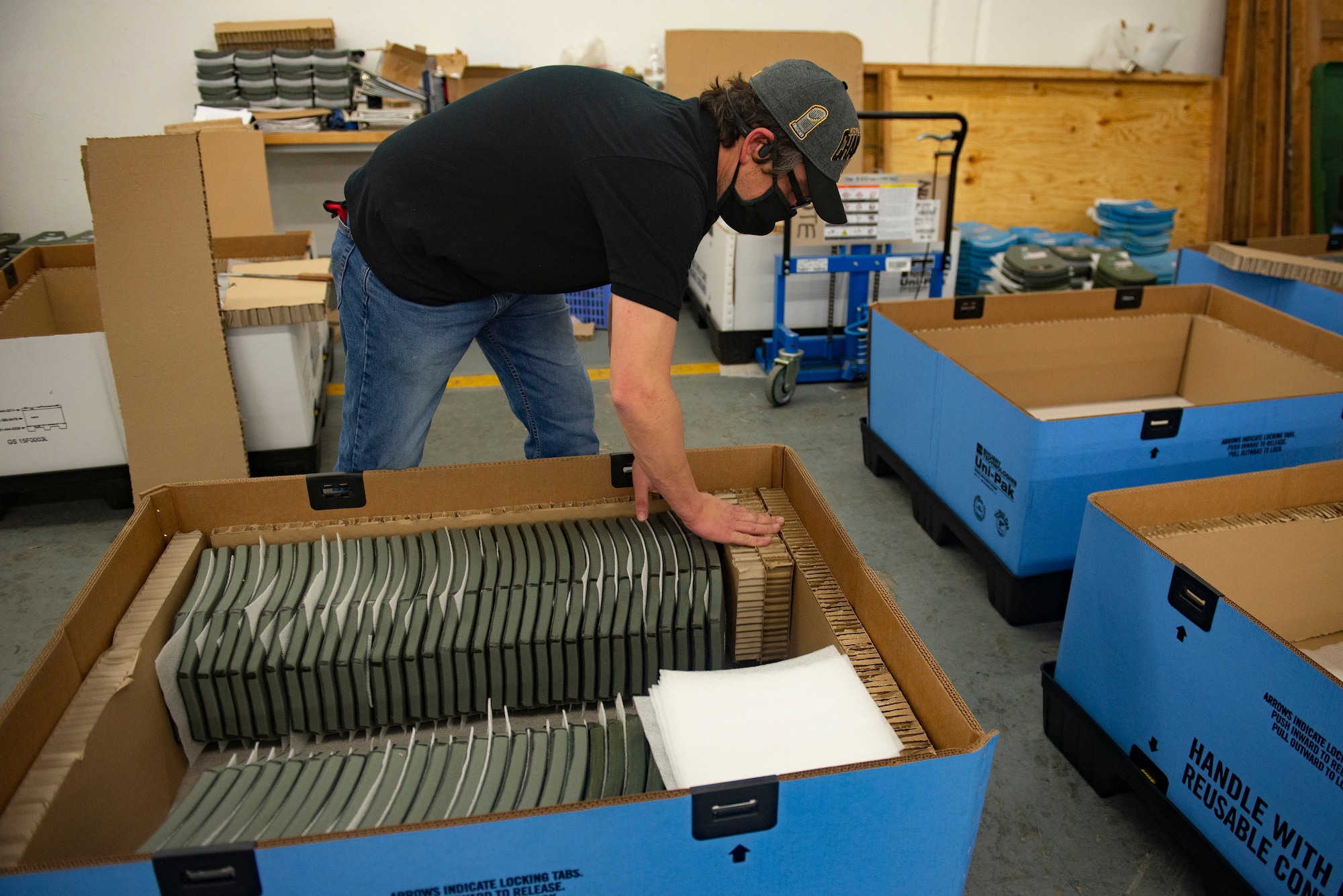 Dennis Brazinski, a Department of Defense contractor, packs inspected ballistic vest plates into shipping crates at Ramstein Air Base, Germany, Oct. 29, 2020.