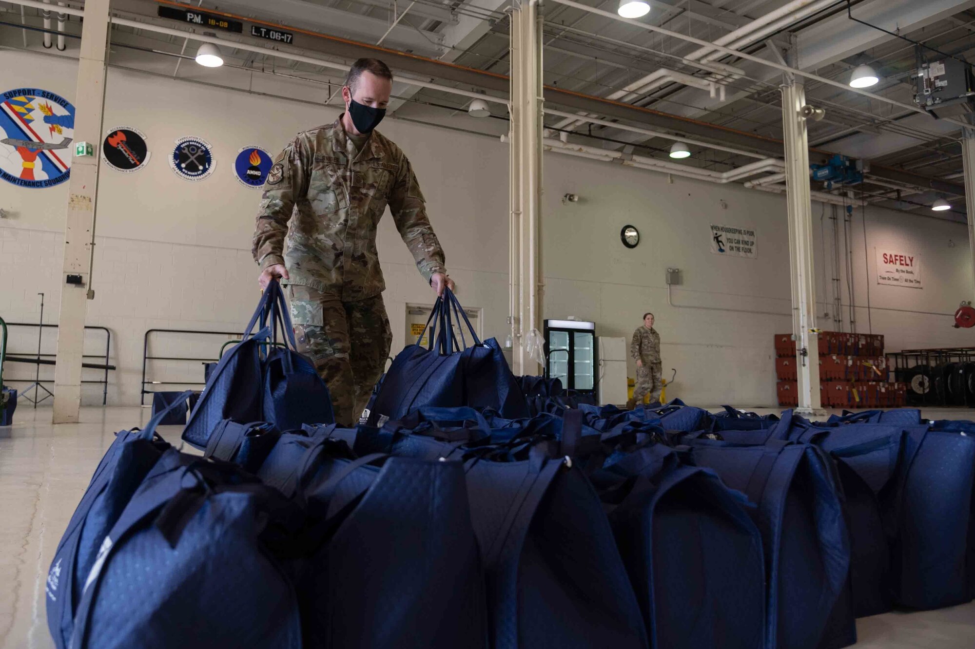 Master Sgt. Kenny Snider, 436th Maintenance Squadron first sergeant, prepares Thanksgiving holiday food bags Nov. 23, 2020, at Dover Air Force Base, Delaware. Dover first sergeants, Key Spouses, Dover Spouses Group and other volunteers helped deliver 260 bags of Thanksgiving dinner kits for Airmen including two whole chickens, canned vegetables and pie ingredients. (U.S. Air Force photo by Airman 1st Class Faith Schaefer)
