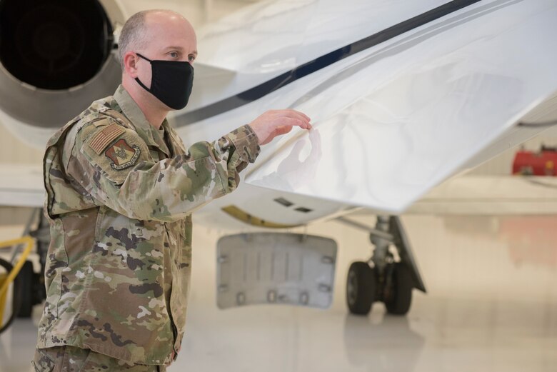 Master Sgt. Jonathon Tolbert, 375th Operations Group contracting officer representative from Scott Air Force Base, Illinois, inspects the new “delta fins” added to the Air Force C-21A, Nov. 10, 2020, at Newton City Airport, Kansas.  The addition of the fins reduces an effect known as the “dutch roll”, where the aircraft rocks from side-to-side while traveling at low speeds. (U.S. Air Force photo by Staff Sgt. Nathan Eckert)