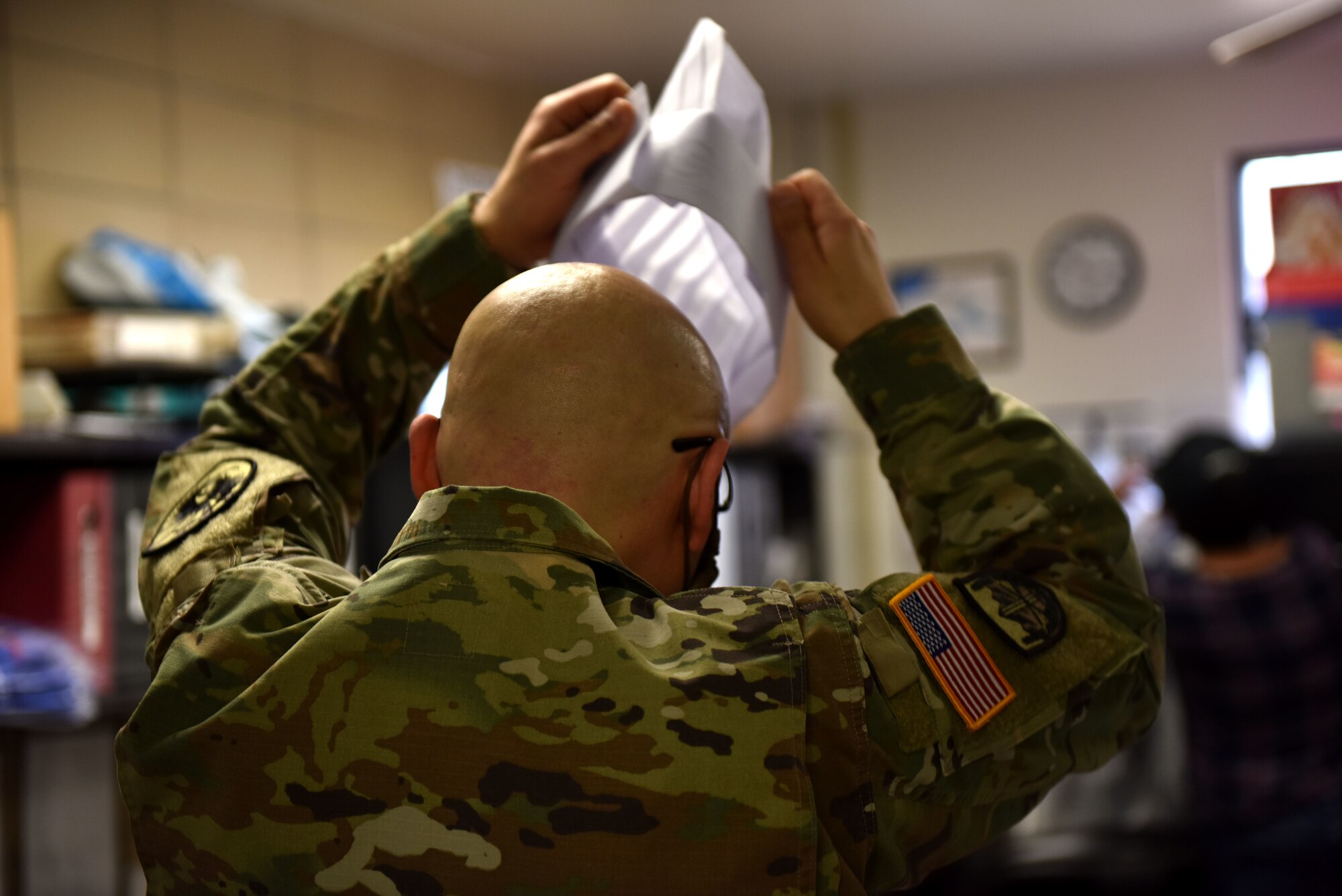 A volunteer prepares to serve Thanksgiving meal to Goodfellow members who could not go home this year at the Western Winds Dining Facility on Goodfellow Air Force Base, Texas, Nov. 26, 2020. Leadership from multiple squadrons and tenant units supported active duty members by serving a Thanksgiving meal.  (U.S. Air Force photo by Staff Sgt. Seraiah Wolf)