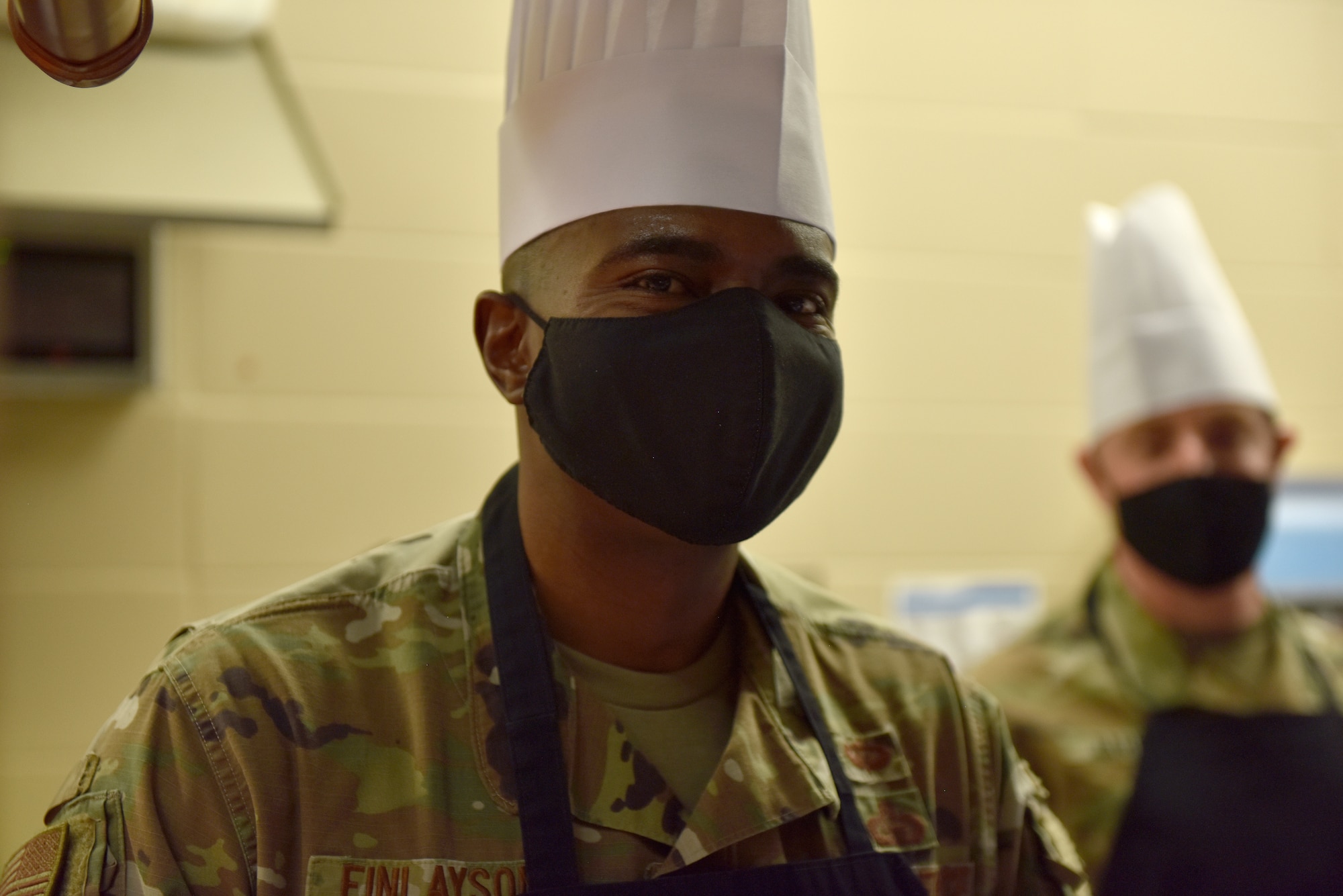 U.S. Air Force Col. James Finlayson, 17th Training Wing vice commander, serves students as they progress down the line during the Thanksgiving meal at the Western Winds Dining Facility on Goodfellow Air Force Base, Texas, Nov. 26, 2020. Leadership from different squadrons as well as other branches served the meal to show support for those who spent their Thanksgiving away from home. (U.S. Air Force photo by Staff Sgt. Seraiah Wolf)