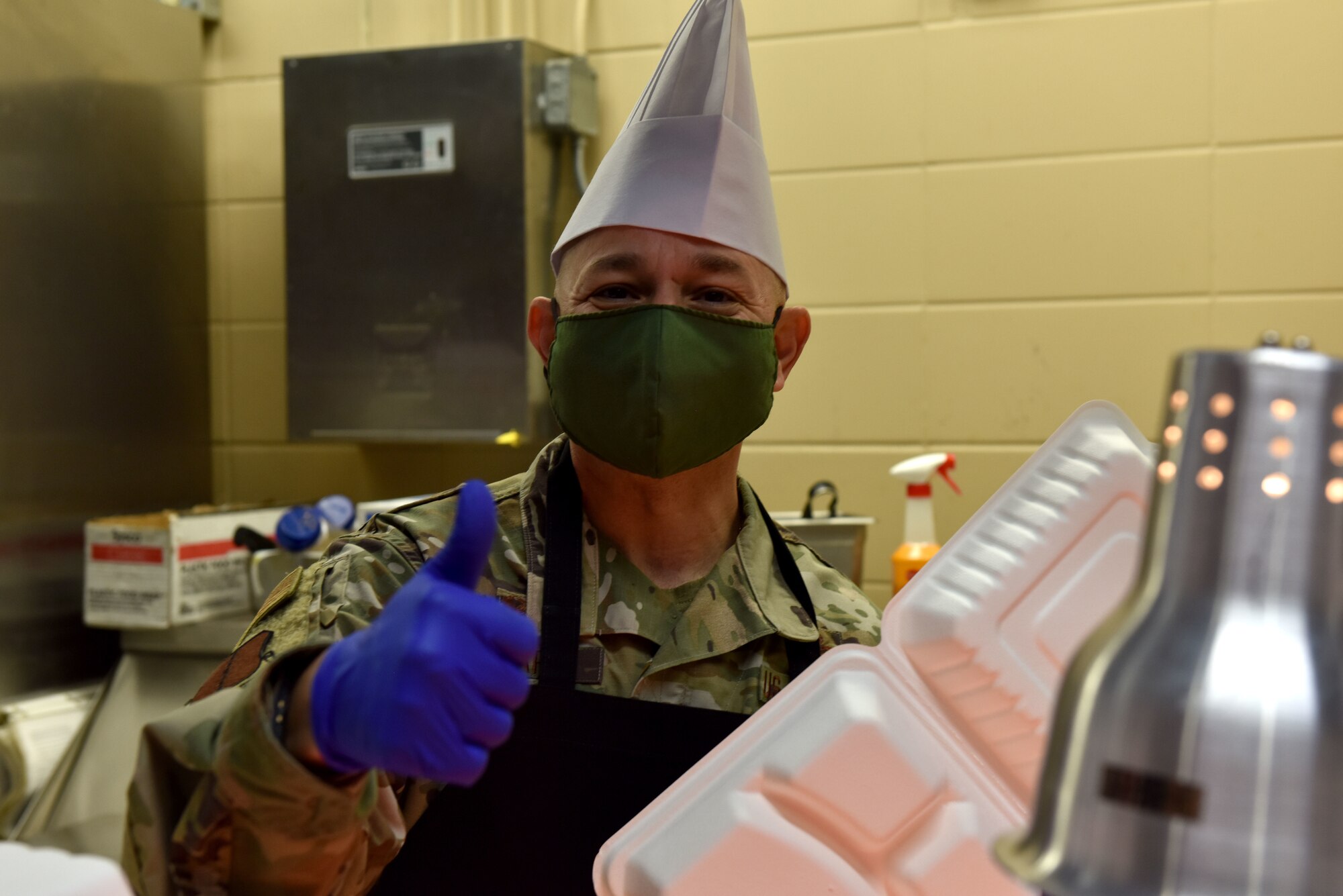 U.S. Air Force Col. Andres Nazario, 17th Training Wing commander, gives a thumbs up while serving Goodfellow members a Thanksgiving meal at the Western Winds Dining Facility on Goodfellow Air Force Base, Texas, Nov. 26, 2020. The meal was open to those who stayed on the base over the Thanksgiving break, and family members who came to visit. (U.S. Air Force photo by Staff Sgt. Seraiah Wolf)