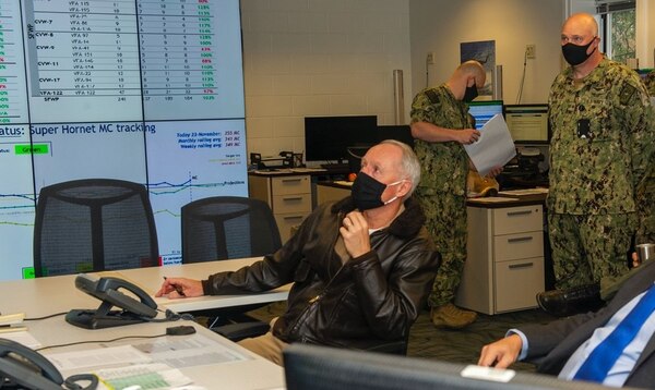 Vice Adm. Kenneth Whitesell, center, commander of Naval Air Forces, is briefed on aircraft readiness in the maintenance operation center at Commander, Naval Air Force Atlantic headquarters.
