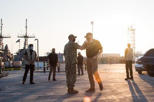 201125-N-IO414-1035 NAVAL SUPPORT ACTIVITY BAHRAIN (Nov. 25, 2020) Capt. Christopher Gilbertson, commanding officer of Commander, Task Force (CTF) 55, left, greets Acting Secretary of Defense, Christopher C. Miller during a visit on board Naval Support Activity Bahrain, Nov 25. CTF 55 commands surface forces such as U.S. Navy patrol craft, U.S. Coast Guard patrol boats and independently deployed ships in U.S. 5th Fleet area of operations, which encompasses nearly 2.5 million square miles of water area and includes the Arabian Gulf, Gulf of Oman, Red Sea and parts of the Indian Ocean. The region is comprised of 20 countries and includes three critical choke points at the Strait of Hormuz, the Suez Canal and the Strait of Bab-al-Mandeb at the Southern tip of Yemen.