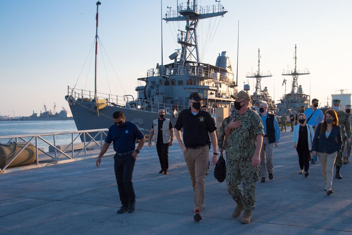 201125-N-IO414-1076 NAVAL SUPPORT ACTIVITY BAHRAIN (Nov. 25, 2020) Capt. Christopher Gilbertson, commanding officer of Commander, Task Force (CTF) 55, right, speaks to Acting Secretary of Defense, Christopher C. Miller during a visit on board Naval Support Activity Bahrain, Nov 25. CTF 55 commands surface forces such as U.S. Navy patrol craft, U.S. Coast Guard patrol boats and independently deployed ships in U.S. 5th Fleet area of operations, which encompasses nearly 2.5 million square miles of water area and includes the Arabian Gulf, Gulf of Oman, Red Sea and parts of the Indian Ocean. The region is comprised of 20 countries and includes three critical choke points at the Strait of Hormuz, the Suez Canal and the Strait of Bab-al-Mandeb at the Southern tip of Yemen.