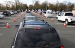 Lines of cars wait at a drive-thru coronavirus testing site.