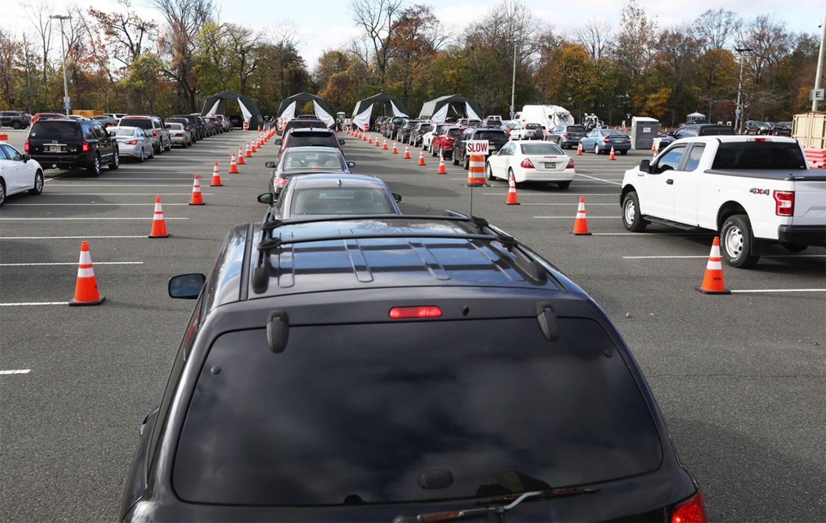 Lines of cars wait at a drive-thru coronavirus testing site.