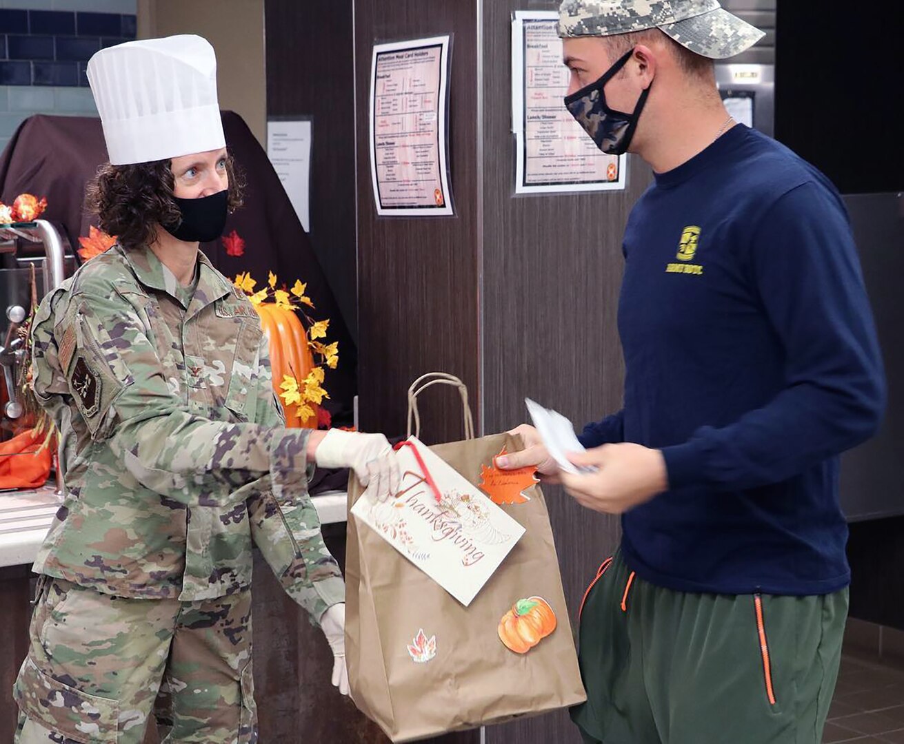 Air Force Col. Heather Yun, Brooke Army Medical Center Deputy Commander for Medical Services, hands a pre-packaged Thanksgiving Day meal to a staff member Nov. 26.