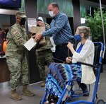 Army Brig. Gen. Shan K Bagby, Brooke Army Medical Center commanding general, wife Melanie, and daughter Sydney (far left), and Army Command Sgt. Maj. Thurman Reynolds and his wife Tommi, and daughters Teigen and Alexis (far right), prepare to deliver Thanksgiving baskets to inpatients Nov. 26.