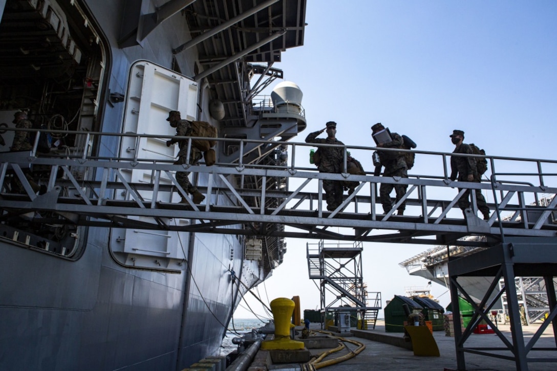 201004-M-UV498-1251 SAN DIEGO (Oct. 4, 2020) – Marines and Sailors with the 15th Marine Expeditionary Unit salute the U.S. flag before embarking aboard the amphibious assault ship USS Makin Island (LHD 8) at Naval Base San Diego, California. The Makin Island Amphibious Ready Group and the 15th MEU are currently conducting routine operations in the eastern Pacific Ocean. (U.S. Marine Corps photo by Lance Cpl. Mackenzie Binion)