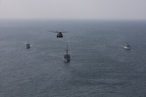Royal Saudi Naval Force mine countermeasures vessel Shaqra (422), left, mine countermeasure ship USS Dextrous (MCM 13), middle, Royal Navy mine countermeasures vessel HMS Brocklesby (M 33) and a MH-53E Sea Dragon helicopter, attached to Helicopter Mine Countermeasures Squadron 15, sail in formation during mine countermeasures interoperability training, led by Commander, Task Force (CTF) 52 in the Arabian Gulf, Nov. 11. CTF 52 provides command and control of all mine warfare assets in the U.S. 5th Fleet area of operations. The 5th Fleet area of operations encompasses about 2.5 million square miles of water area and includes the Arabian Gulf, Arabian Sea, Gulf of Oman, Red Sea and parts of the Indian Ocean. The expanse is comprised of 20 countries and includes three critical choke points at the Strait of Hormuz, the Suez Canal and the Bab el-Mandeb Strait at the southern tip of Yemen.