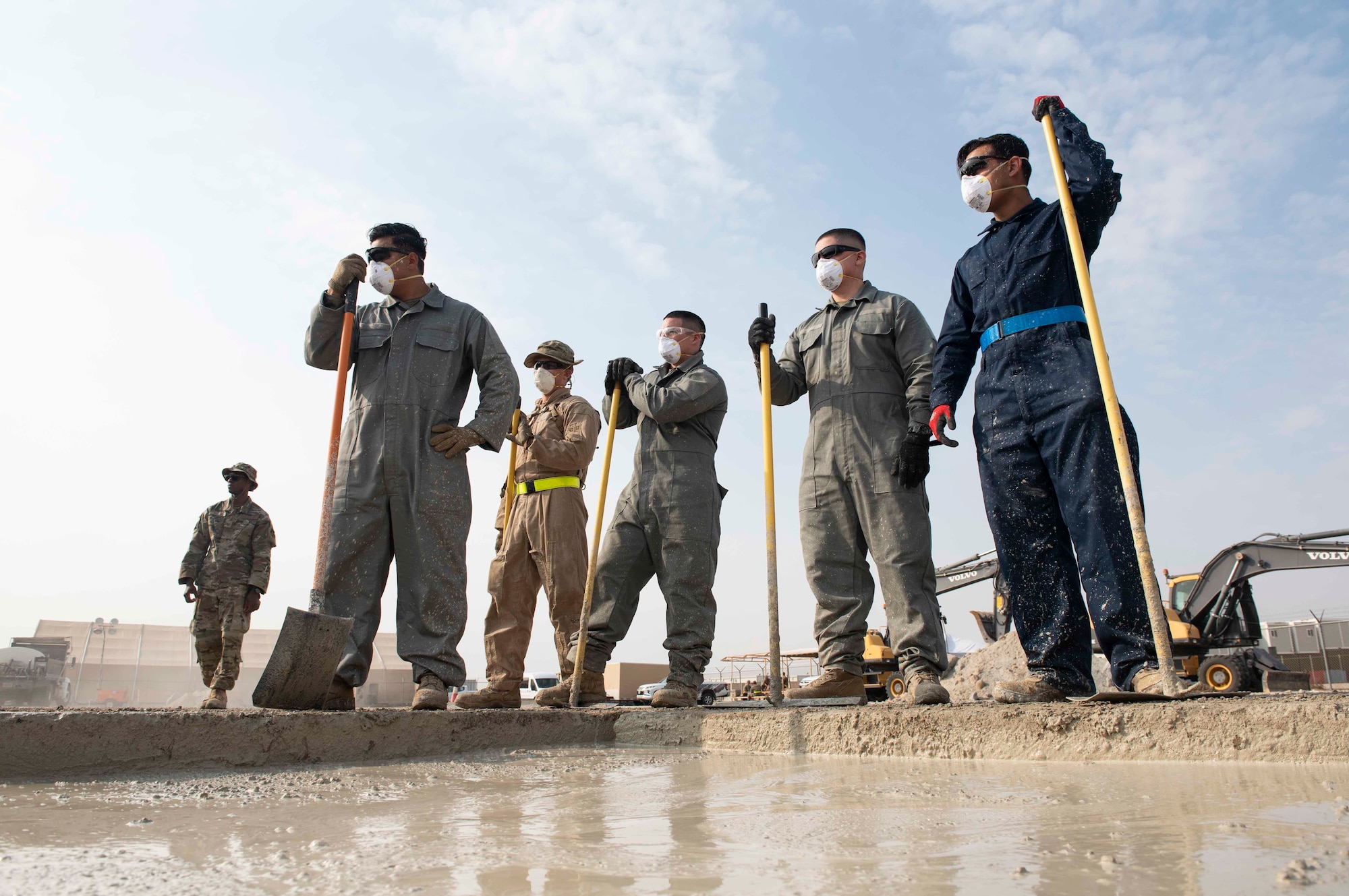 U.S. Air Force Airmen from the 386th Expeditionary Civil Engineer Squadron prepare to spread and even out rapid set concrete during a Rapid Airfield Damage Recovery training exercise at Ali Al Salem Air Base, Kuwait, Nov. 16, 2020. The materials, combined with new techniques and equipment, create stronger repairs allowing for thousands of passes for aircraft compared to the old repair process. (U.S. Air Force photo by Staff Sgt. Kenneth Boyton)