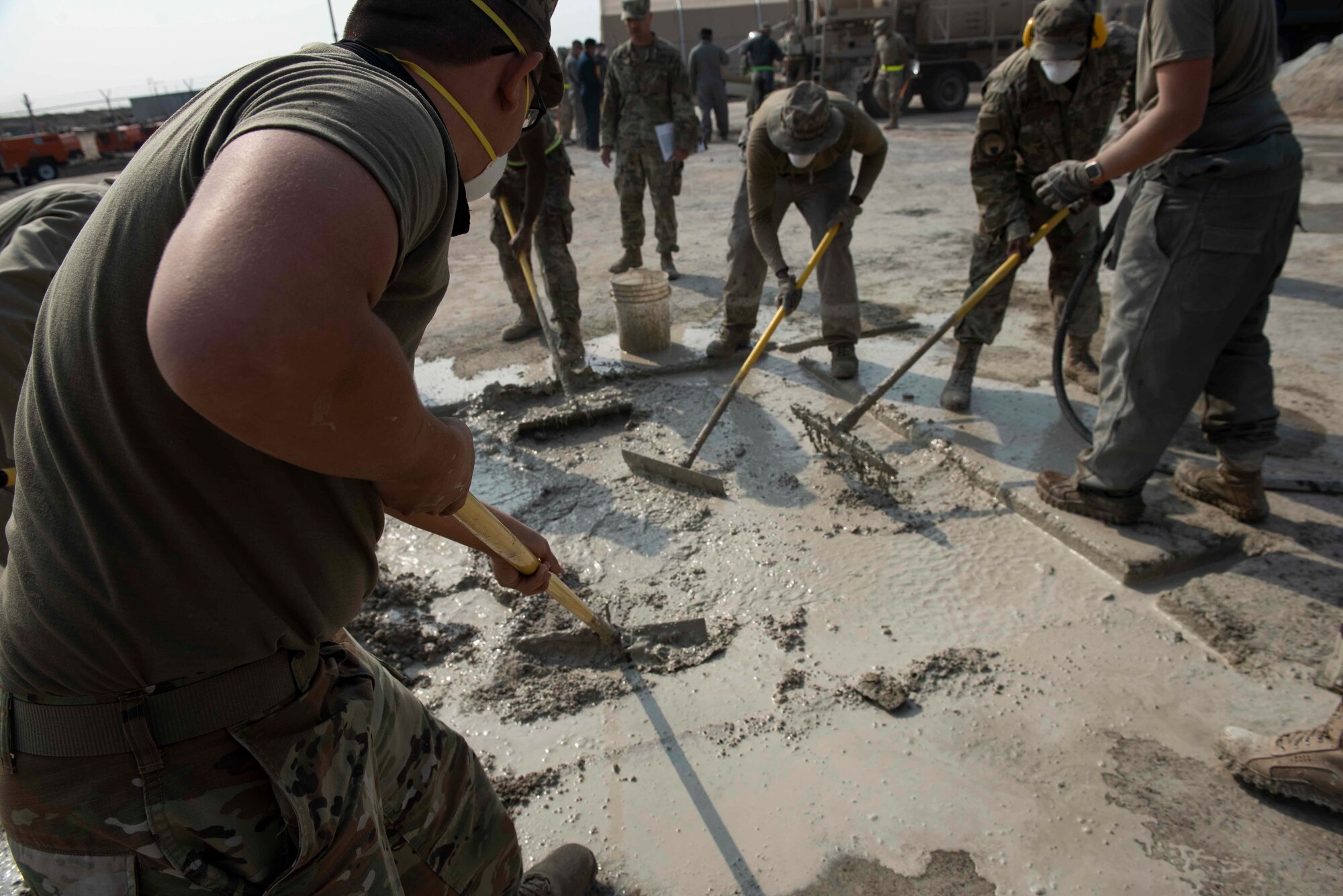 U.S. Air Force Airmen from the 386th Expeditionary Civil Engineer Squadron spread out rapid set concrete during a Rapid Airfield Damage Recovery training exercise at Ali Al Salem Air Base, Kuwait, Nov. 16, 2020. After being repaired, the patch can tolerate thousands of aircraft passes, allowing the flying mission to continue unimpeded. (U.S. Air Force photo by Staff Sgt. Kenneth Boyton)