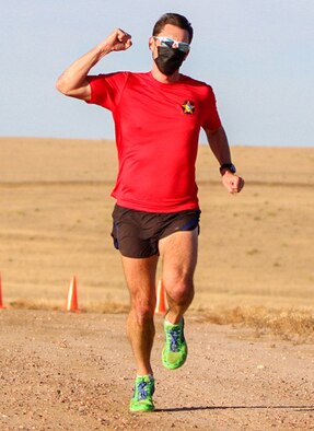 Maj. Jason Brosseau, 26th Space Aggressors Squadron, raises his fist as he approaches the finish line Nov. 20, 2020, at Schriever Air Force Base, Colorado during the 19th annual Turkey Trot race. Brosseau’s finish marked his third consecutive victory in the event. (U.S. Space Force photo by Marcus Hill)