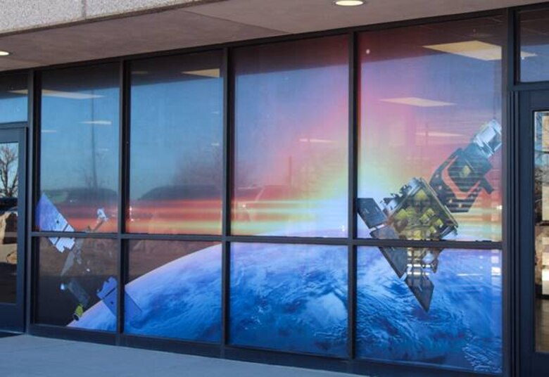 Windows at the restricted area North Portal display satellites as part of the “Life Series,” created by the 50th Mission Support Group at Schriever Air Force Base, Colorado. The series will include Air and Space Force-related photos to highlight Airmen who work within the RA. Photos displayed indoors will include squadrons such as the 50th Security Forces Squadron, 50th Civil Engineer Squadron, the dining facility and more. Images displayed on windows will be completed when weather permits. 
(U.S. Space Force photo by Marcus Hill)