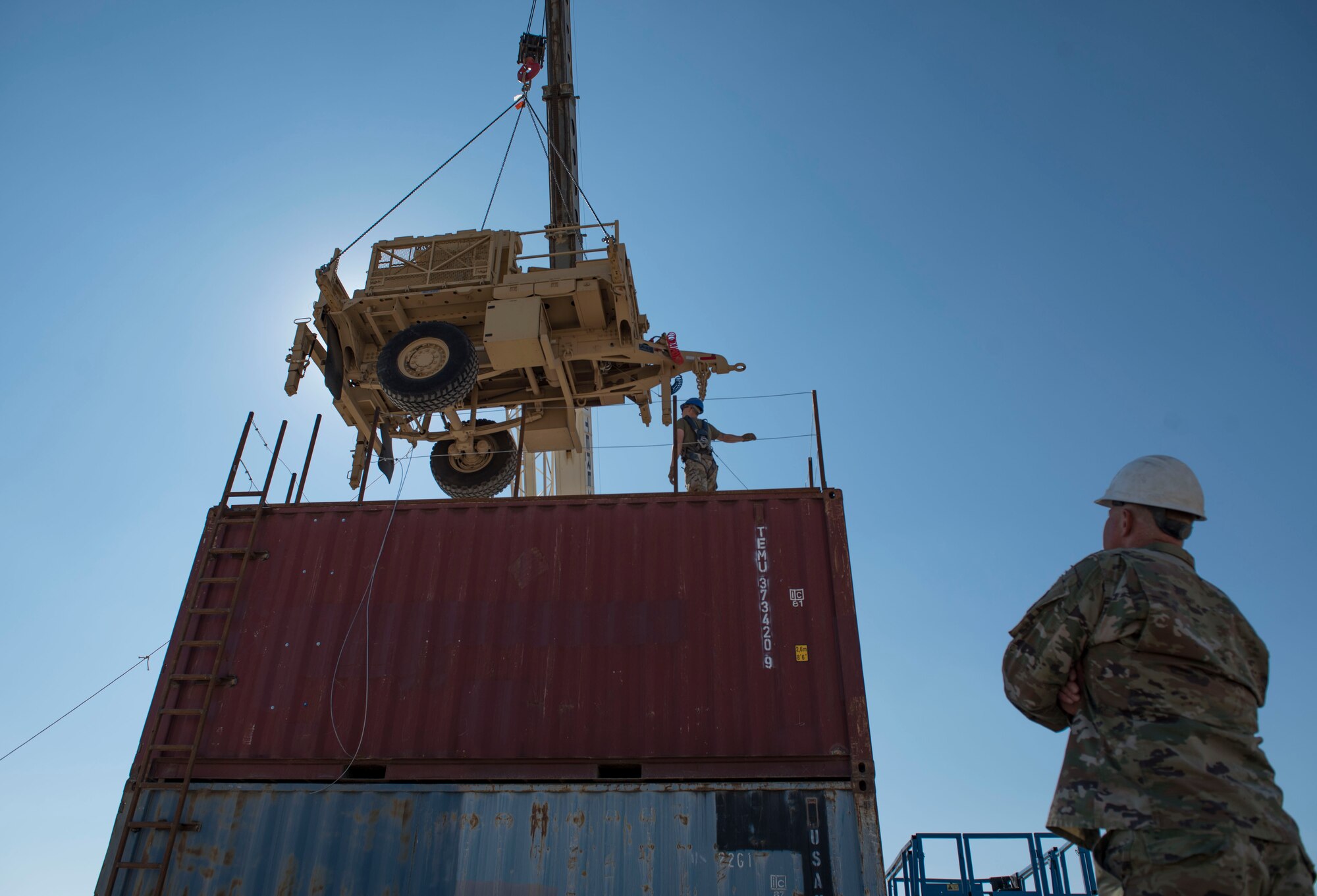 U.S. Air Force Airmen assigned to the 386th Expeditionary Civil Engineer Squadron lower an AN/MQP-64 Sentinel radar onto an elevated structure at Ali Al Salem Air Base, Kuwait, Nov. 23, 2020.