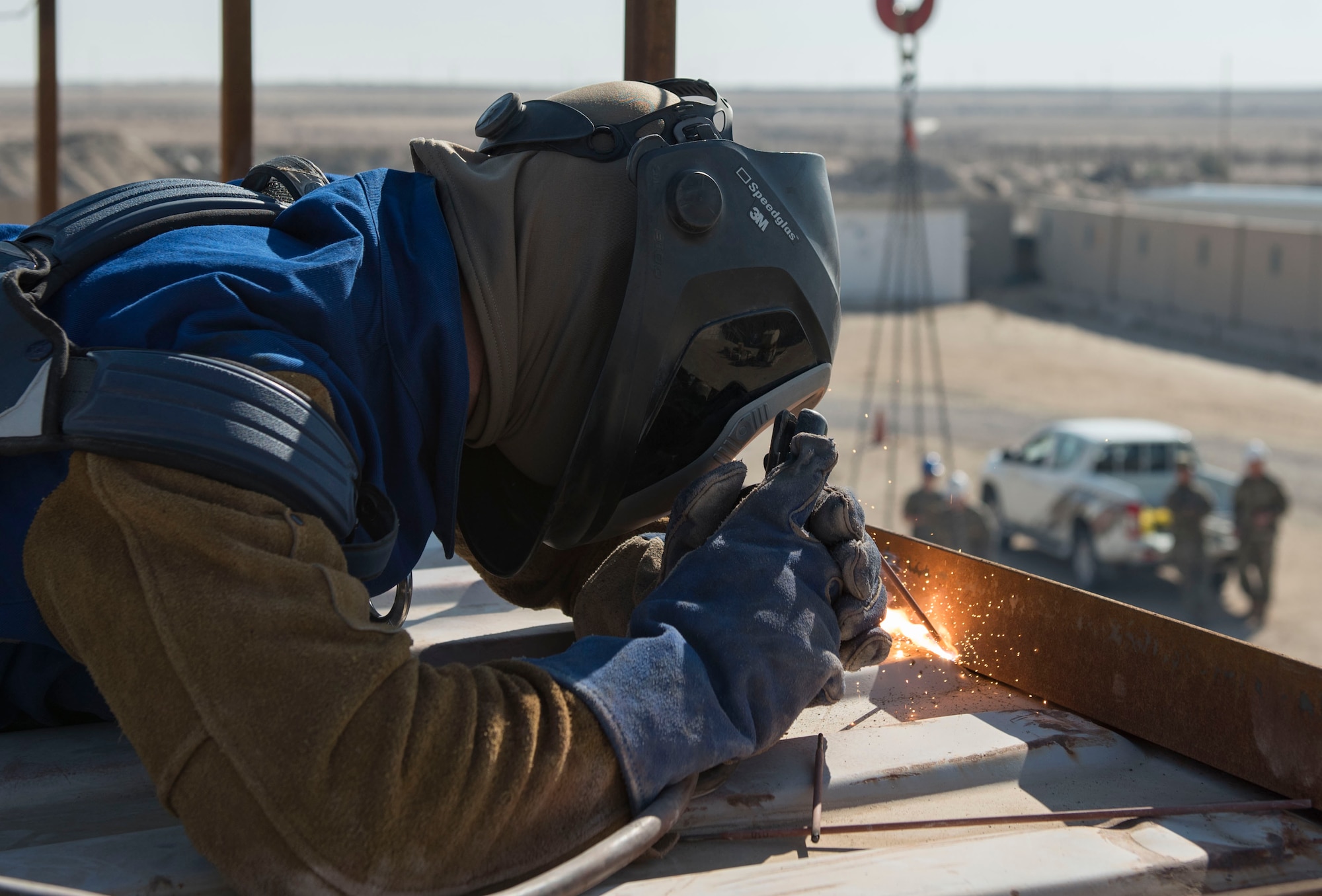 A U.S. Air Force Airman assigned to the 386th Expeditionary Civil Engineer Squadron structures unit welds a rail to a conex at Ali Al Salem Air Base, Kuwait, Nov. 23, 2020.