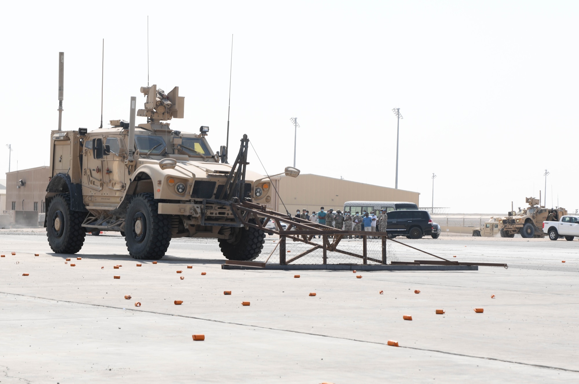 U.S. Airmen assigned to the 379th Expeditionary Civil Engineer Squadron explosive ordnance disposal branch, drive a mine-resistant ambush-protected all-terrain vehicle during rapid airfield damage repair training at Al Udeid Air Base, Qatar, Nov. 18, 2020. They used the M-ATV to clear simulated unexploded ordnance from a training field before engineers came through during the next phase of RADR training, which prepares ECES Airmen to make expeditious repairs to an airfield after it has been damaged in an attack. (U.S. Air Force photo by Staff Sgt. Kayla White)