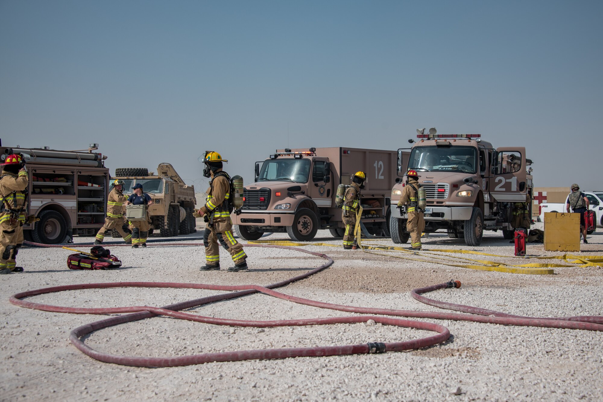 firefighters work to clean up hoses