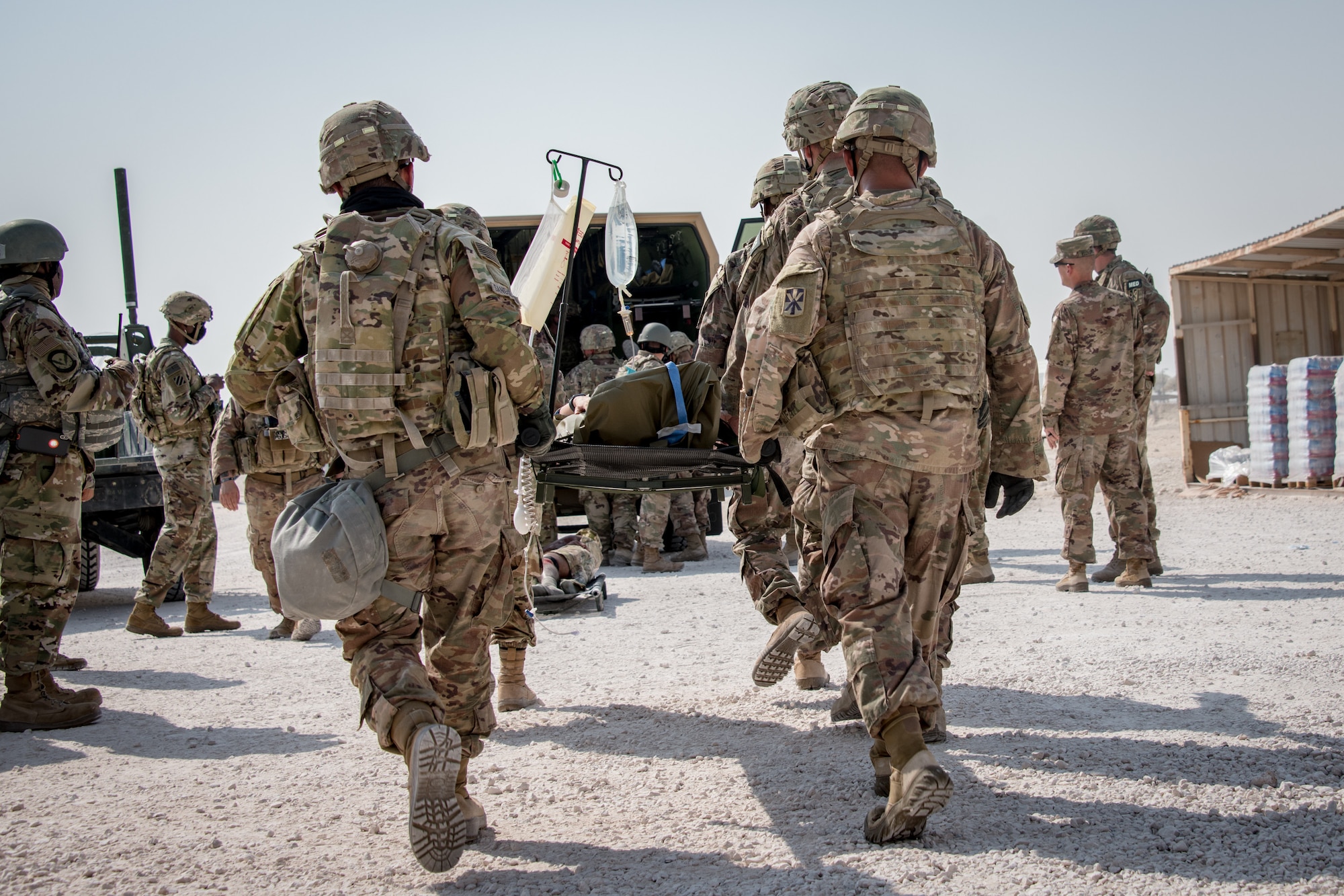 U.S. soldiers carry a litter to an emergency transportation vehicle