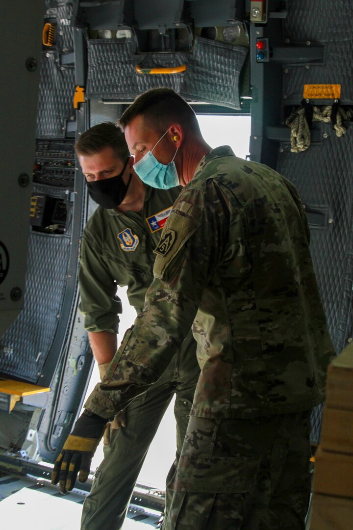 Lt. Col. Jeremy Gottshall (right), U.S. Army North’s Task Force 51’s logistic officer in charge, talks with Air Force Tech Sgt. Matt Legendre (left), a loadmaster assigned to the 68th Airlift Squadron, during the unit’s Level II Deployment Readiness Exercise at the Joint Base San Antonio-Kelly Field Annex Nov. 20.