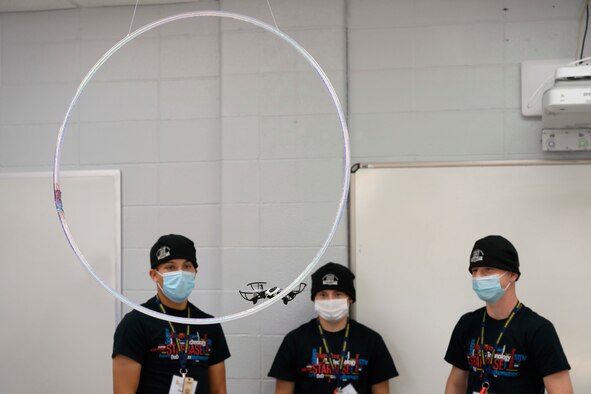 Students with the Louisiana National Guard Youth program watch as a drone flies through a hula hoop.