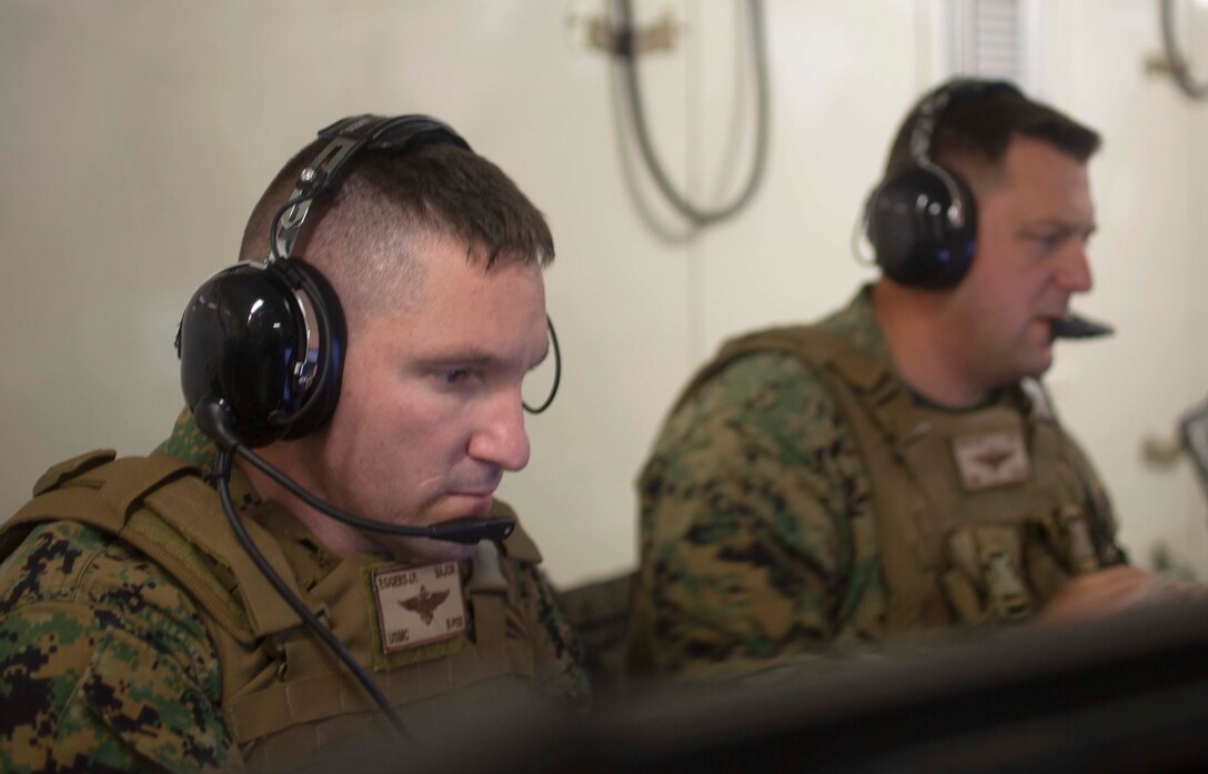 United States Marine Corps Senior watch officers, Maj. Jeffery Eggers, Maj. Andrew Casci (1st Maw HQ), review information from subordinate units during Marine Expeditionary Force Exercise 2019 (MEFEX 19) at the Tactical Air Control Center (TACC) aboard Marine Corps Air Station Futenma, Okinawa, Japan, on May 2, 2019. MEFEX 19, a command and control exercise conducted in a simulated deployed environment, is designed to synchronize and bring to bear the full spectrum of III MEF, while remaining ready to provide the Marine Corps with an experienced staff capable of integrating with international allies and partner nations in a combined joint task force, charged with accomplishing a wide range of military operations. (U.S. Marine Corps Photo by Sgt. Ronald H. Spotswood)