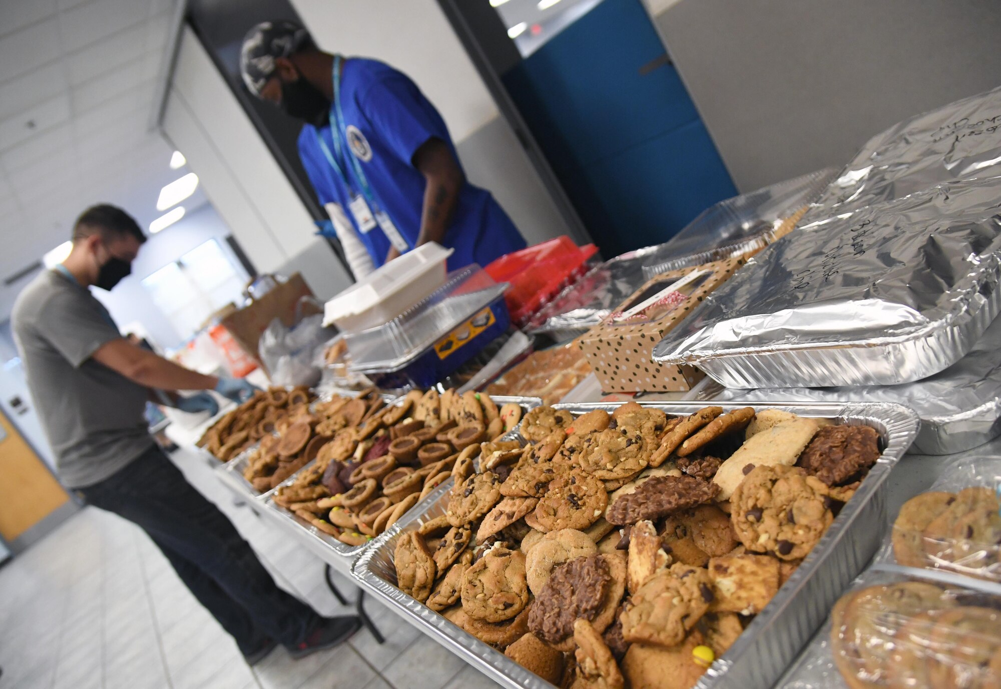 Airmen from the 81st Training Group sort cookies inside the Levitow Training Support Facility at Keesler Air Force Base, Mississippi, Nov. 26, 2020. Due to the concern over rising COVID-19 cases, 81st TRG students weren't allowed to leave Keesler for the holidays. Keesler personnel were asked to donate cookies to the students to increase moral.(U.S. Air Force photo by Kemberly Groue)