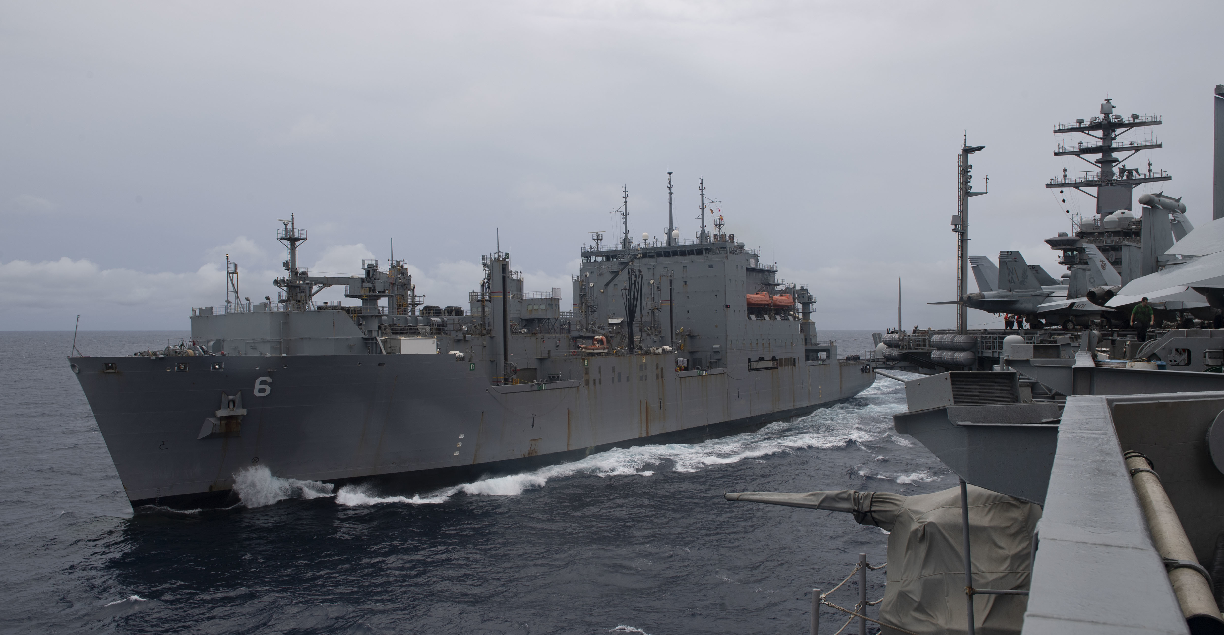 The Lewis and Clark-class dry cargo ship USNS Amelia Earhart (T-AKE-6) steams alongside the aircraft carrier USS Nimitz (CVN 68) during a replenishment-at-sea evolution.