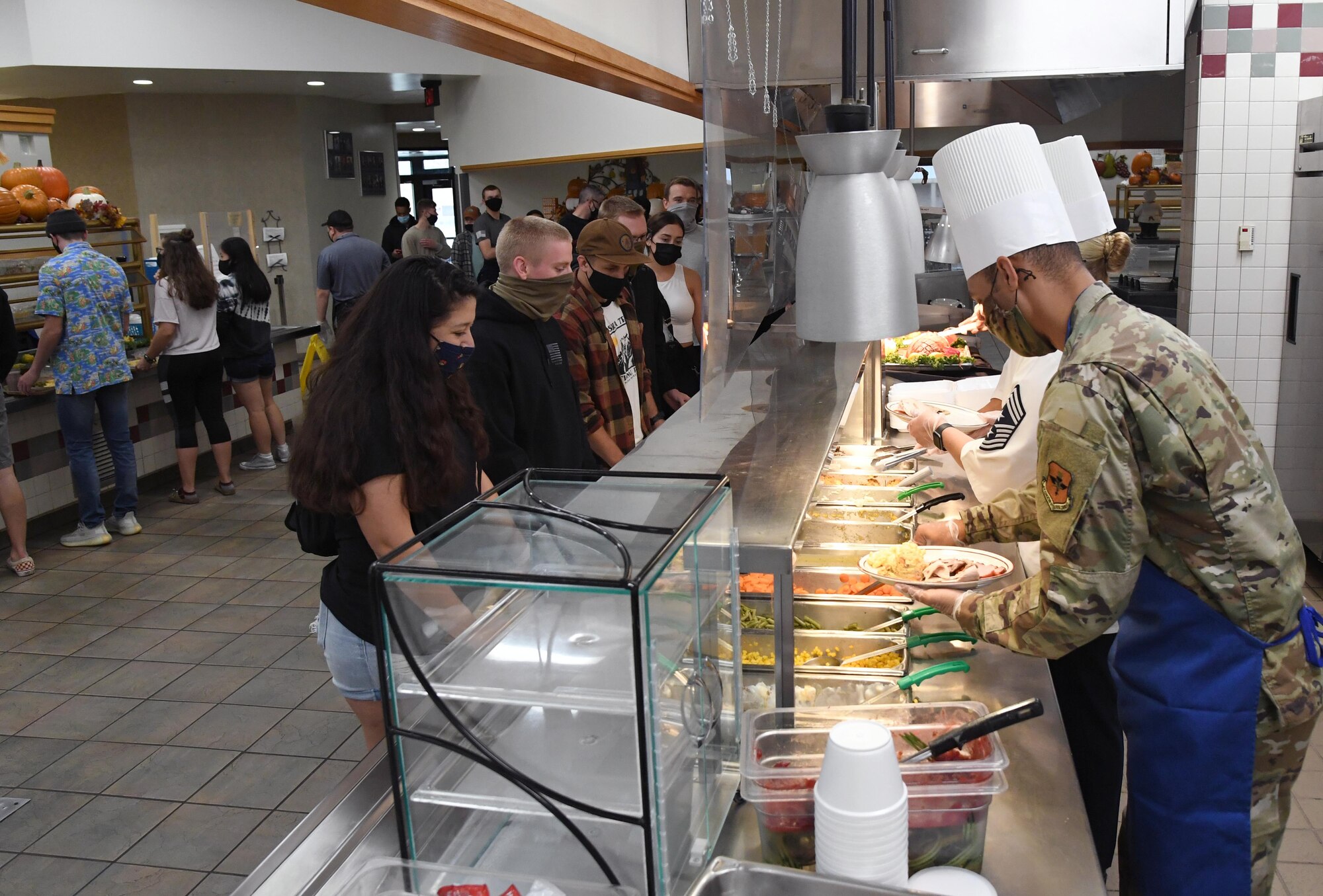 Keesler leadership serves lunch to 81st Training Group students inside the Azalea Dining Facility at Keesler Air Force Base, Mississippi, Nov. 26, 2020. It is tradition at Keesler for commanders, first sergeants and superintendents to serve a Thanksgiving meal at the dining facility to technical training and permanent party Airmen who are not able to go home for the holiday. (U.S. Air Force photo by Kemberly Groue)