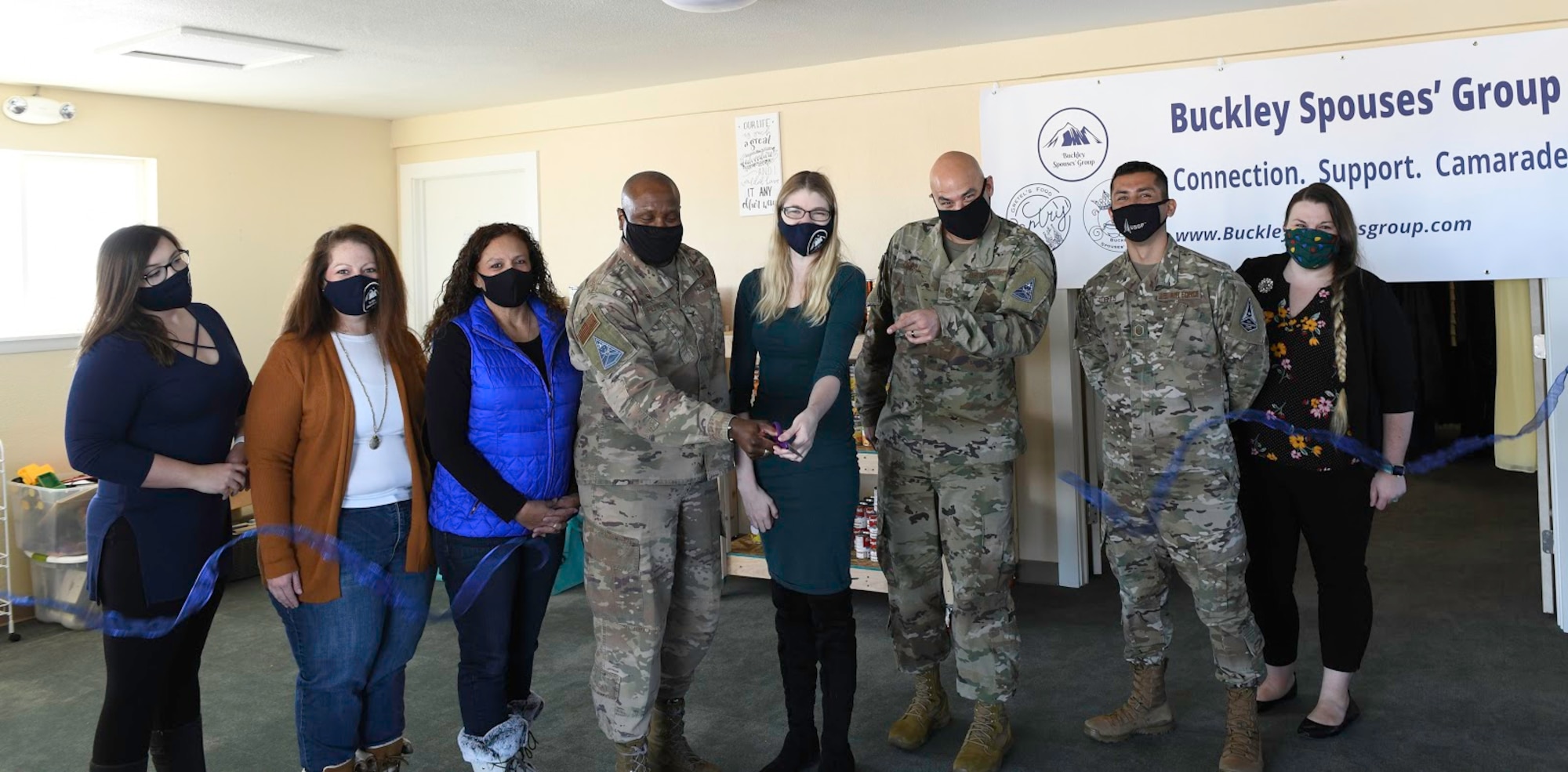 Col. Devin Pepper, Buckley Garrison commander, and Rachel Crist, Buckley Spouses’ Group treasurer, cut a ribbon at the Grand opening of Gretel’s Food Pantry on Buckley Air Force Base Colo., Nov. 25, 2020. Various volunteers have worked tirelessly since late March to convert a portion of the Buckley Spouses’ Group Resource Center into a food pantry to help meet the needs of families on Buckley. (U.S. Space Force photo by Airman 1st Class Haley N. Blevins)